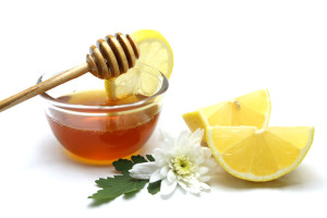 Honey and lemon on white background