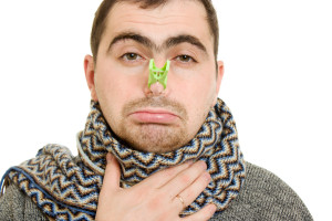 A patient man with a stuffy nose on a white background.