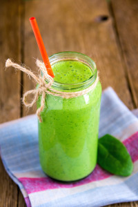 Green spinach smoothie in glass jar
